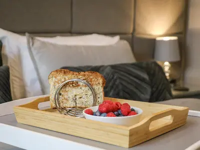 a tray with a loaf of bread and berries on a table at Kilmory Lodge in Poulton le Fylde