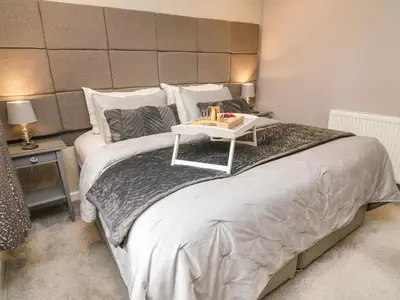 a large bed with a table on top of it at Kilmory Lodge in Poulton le Fylde