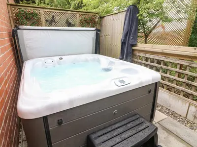 a jacuzzi tub sitting in a backyard at Kilmory Lodge in Poulton le Fylde
