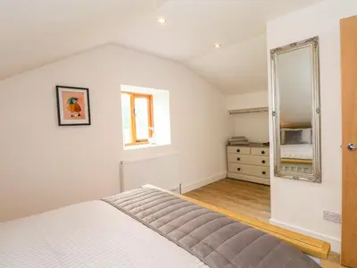 a bedroom with a bed and a mirror at The Croft in Chorley