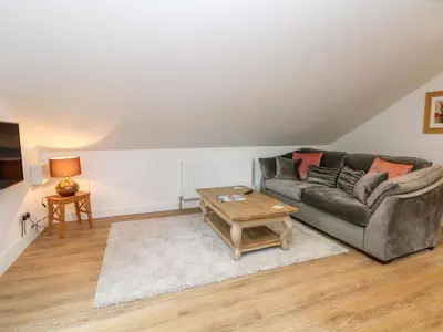 a living room with a couch and a table at The Croft in Chorley