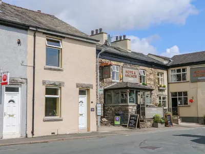 an old building on the corner of a street at Molly's Cottage in Grange Over Sands
