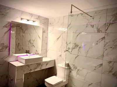 a bathroom with a toilet and a sink and a shower at Salt-Rock in Blackpool