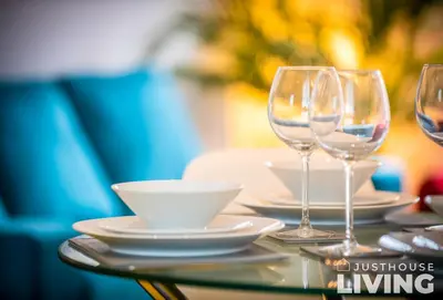 a table with wine glasses and a bowl on it at NEW Spacious Modern Townhouse Sleeps 12 Free Parking in Liverpool