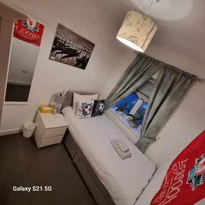 a small bedroom with a bed and a window at Liverpool Anfield in Liverpool