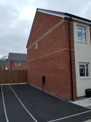 a brick building with a parking lot next to it at Liverpool Anfield in Liverpool