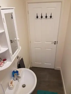 a bathroom with a white sink and a mirror at Liverpool Anfield in Liverpool