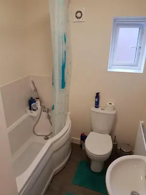 a bathroom with a toilet and a tub and a sink at Liverpool Anfield in Liverpool