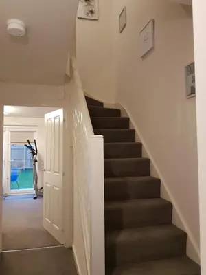 a staircase in a home with white walls and gray stairs at Liverpool Anfield in Liverpool