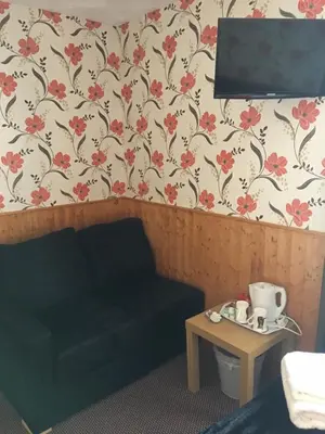 a living room with a couch and a table at Kingscliff in Blackpool