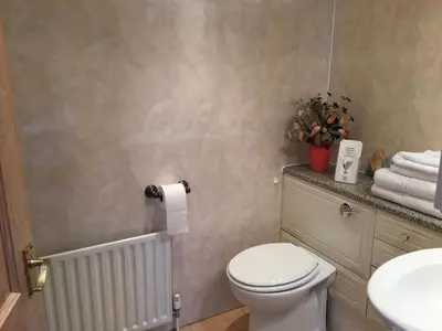 a bathroom with a toilet and a sink and towels at Kingscliff in Blackpool