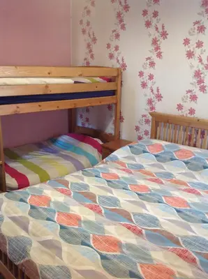 a bedroom with a bed and a bunk bed at Lindisfarne Holiday Apartments - Families & Couples Only in Blackpool