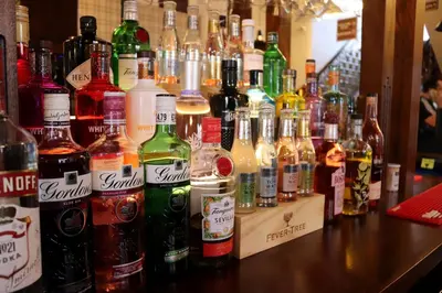 a group of bottles of alcohol on a bar at The Bridge Inn Hotel in Bolton