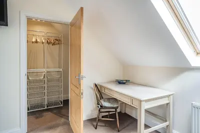 a room with a desk and a closet at Hillberry in Grange Over Sands