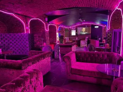 a bar with pink lighting in a room with couches at BEST DEAL - Kings Hotel in Blackburn