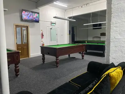 a living room with a pool table and a tv at BEST DEAL - Kings Hotel in Blackburn