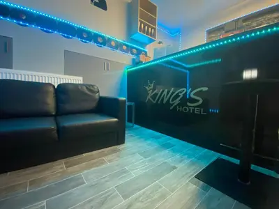 a living room with a couch and a piano at BEST DEAL - Kings Hotel in Blackburn