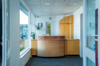 an office lobby with a desk and aitating at The Strathmore Hotel in Morecambe