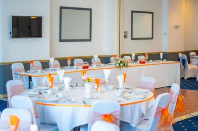 a set of tables and chairs in a room at The Strathmore Hotel in Morecambe