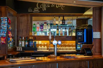 a bar with a lot of bottles of alcohol at The Strathmore Hotel in Morecambe