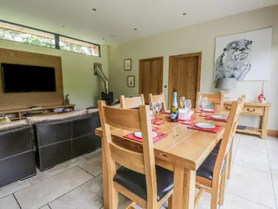 a dining room with a wooden table and chairs at Neddy Cut in Ulverston