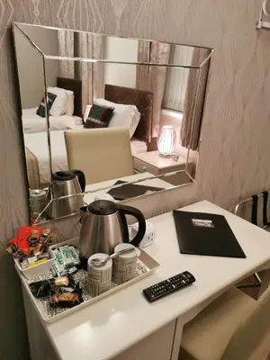 a room with a table with a tea kettle and a mirror at THE QUORN HOTEL in Blackpool