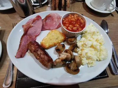 a white plate of food with meat mushrooms rice and beans at THE QUORN HOTEL in Blackpool