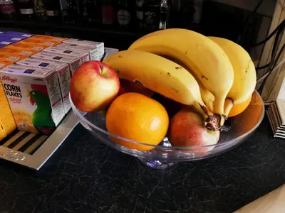a bowl of fruit on a counter with apples oranges and bananas at THE QUORN HOTEL in Blackpool