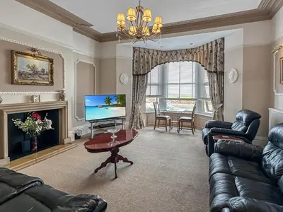a living room with a couch and a television at Granada Apartments Burbage in Blackpool