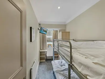 a bedroom with a bunk bed and a desk at Granada Apartments Burbage in Blackpool