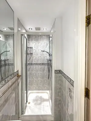 a bathroom with a shower with a tub at Granada Apartments Burbage in Blackpool