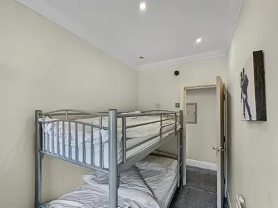 a bunk bed in a room with a staircase at Granada Apartments Burbage in Blackpool