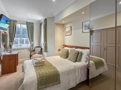 a hotel room with a bed and a window at Granada Apartments Burbage in Blackpool