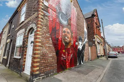 a mural of a man on the side of a brick building at The World Famous Henderson House in Liverpool