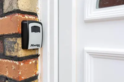 a door latch on a brick wall next to a door at The World Famous Henderson House in Liverpool