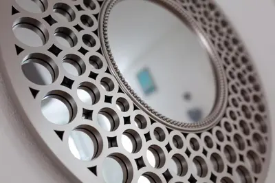 a mirror with a circular design on a wall at The World Famous Henderson House in Liverpool