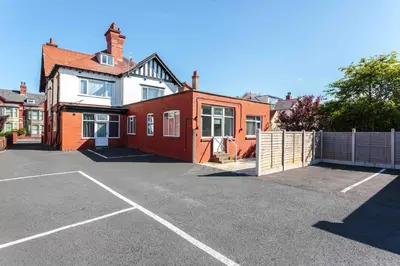 a house with a parking lot in front of it at Cherry Property - Mulberry Suite in Blackpool