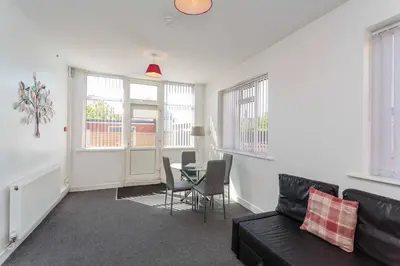 a living room with a couch and a table at Cherry Property - Mulberry Suite in Blackpool