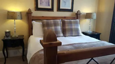 a bedroom with a bed with two lamps on tables at The Ambassador Townhouse in Southport
