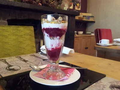 a glass filled with ice cream and berries on a plate at The Ambassador Townhouse in Southport