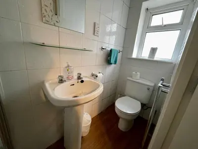 a white bathroom with a sink and a toilet at Beeches Hotel in Blackpool