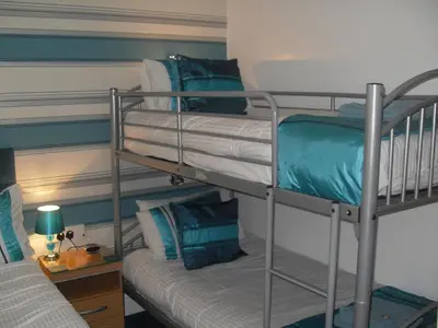 two bunk beds in a room with a couch at Beeches Hotel in Blackpool