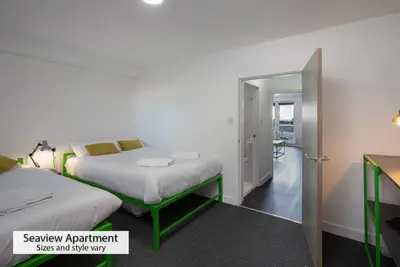 a hotel room with two beds and a hallway at ApartHotel421 by Seafront Collection in Blackpool