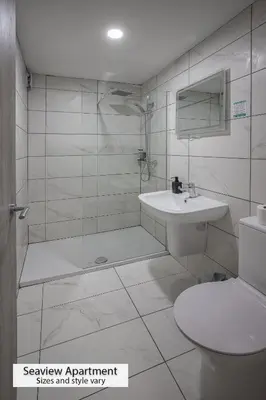 a bathroom with a shower and a sink and a toilet at ApartHotel421 by Seafront Collection in Blackpool