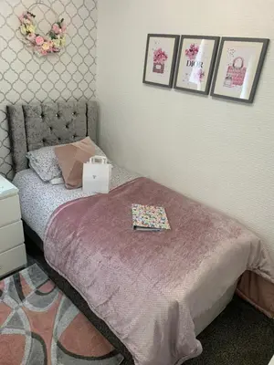 a bedroom with a bed and pictures on the wall at Sorrento House in Blackpool