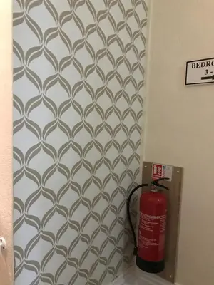 a fire hydrant is next to a wall with a wallpaper at Sorrento House in Blackpool