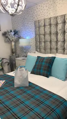 a bedroom with a bed with a bag on it at Sorrento House in Blackpool