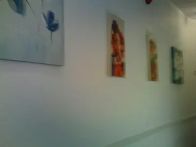 a white wall with four pictures on it at Arlingtons in Blackpool