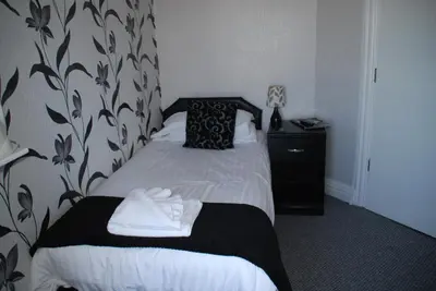 a hotel room with a bed with towels on it at Brincliffe Hotel in Blackpool