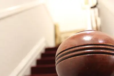 a close up of a wooden rail in front of a staircase at The Ashley in Morecambe